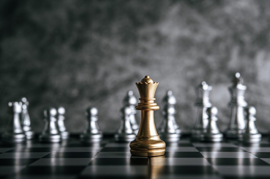 Gold and Silver Chess on chess board game for business metaphor