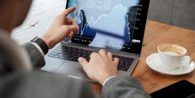 cropped-image-businessman-sitting-by-table-cafe-analyzing-indicators-laptop-computer-scaled-1.jpg