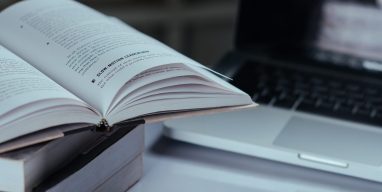 education concept, books and laptop at library